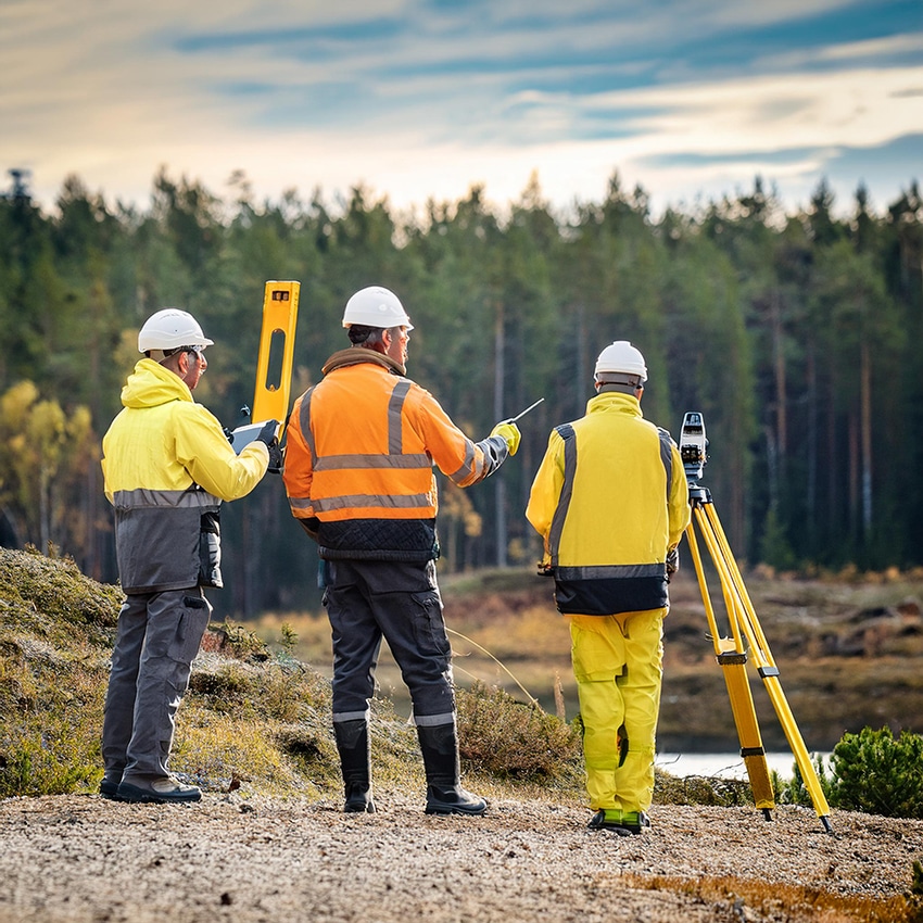 Mätpersonal i fält som genomför inmätning inför lantmäteriförrättning.